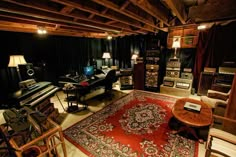 a living room filled with furniture and musical equipment