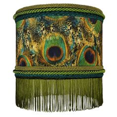 a close up of a lampshade with peacock feathers and fringes on it