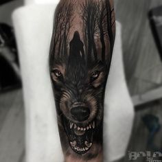 a man with a wolf tattoo on his arm