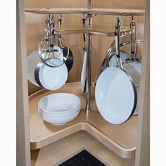 an open cabinet with pots and pans on it