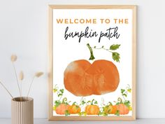 an orange pumpkin with the words, welcome to the pumpkin patch on it is in front of a white wall