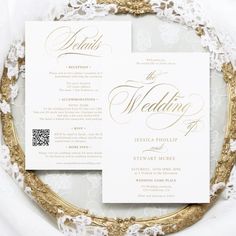 the wedding stationery is displayed in front of a gold frame on a white table cloth