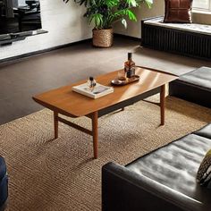 a living room with two couches and a coffee table in front of a tv