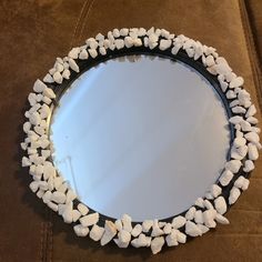 a mirror that has marshmallows on the rim and is sitting on a couch