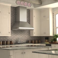 a kitchen with white cabinets and gray counter tops