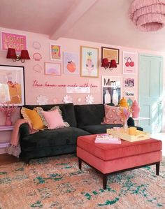 a living room filled with furniture and pictures on the wall next to a pink rug