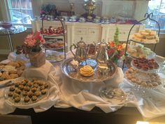 an assortment of pastries and desserts on display in a buffet style setting at a restaurant