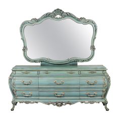 a blue dresser with a mirror on top of it