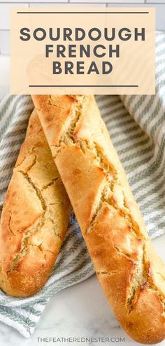 two loaves of sourdough french bread sitting on top of a blue and white towel