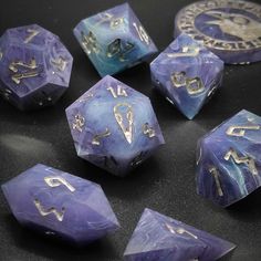 purple and blue dice with gold numbers on them