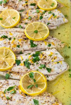 grilled fish with lemons and herbs on a platter, ready to be eaten