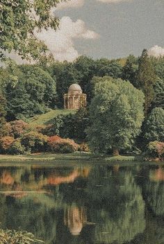 a lake surrounded by trees with a gazebo in the middle and other greenery around it