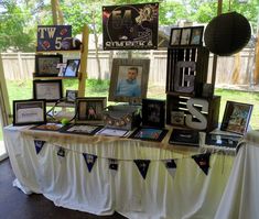 a table with pictures and other items on it in front of a glass wall window