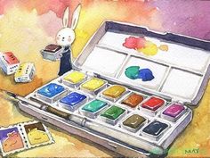 a watercolor painting with an open box of paint next to some stamps and a bunny