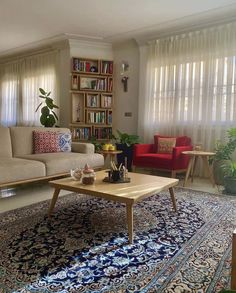 a living room with two couches and a coffee table in front of the window