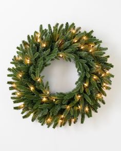 a christmas wreath with lights hanging from it