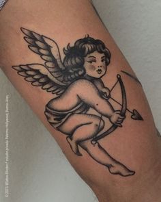 an angel with a bow and arrow tattoo on the arm