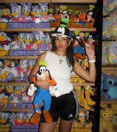 a woman is standing in front of shelves with stuffed animals