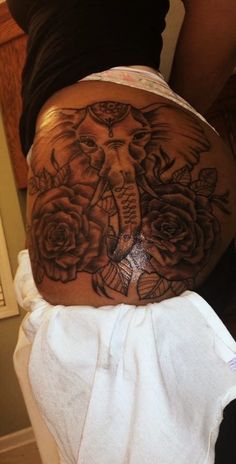 an elephant with roses on its stomach is shown in this photo, it appears to be tattooed