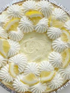 a pie with lemons and meringue on it sitting on top of a table