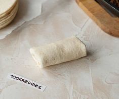 a tortilla sitting on top of a table next to a pile of food