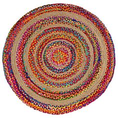 a multicolored round rug on a white background with an oval design in the center