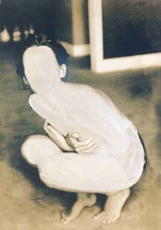 a woman sitting on the ground with her legs crossed