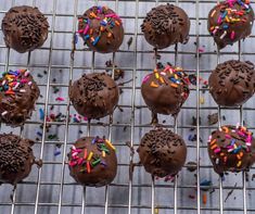 chocolate frosted donuts with sprinkles on a cooling rack, ready to be eaten