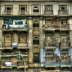 an old building with lots of balconies and clothes hanging on the balconys