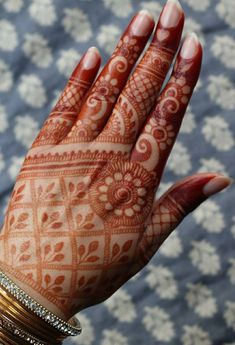 a woman's hand with henna on it