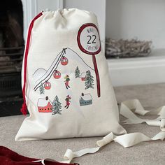 a drawstring bag sitting on the floor next to a fire place with ribbon around it