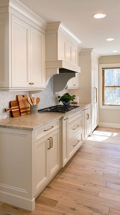 a kitchen with wooden floors and white cabinets