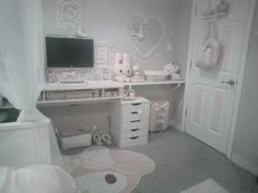 a bedroom with white furniture and lots of pink decorations on the walls, along with a large computer desk