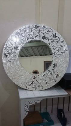 a mirror sitting on top of a white shelf