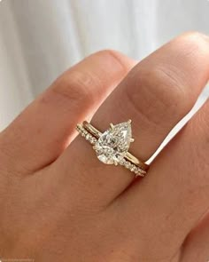 a woman's hand with a diamond ring on it