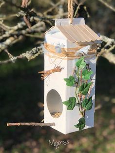 a bird house hanging from a tree branch