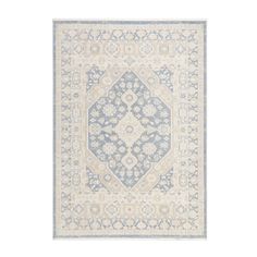 a blue and white rug with an intricate design on the bottom, in front of a white background