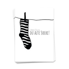 a black and white card with a pair of socks hanging from a clothes line that says, alles que du atte soke