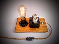 a light bulb sitting on top of a wooden board next to a mouse pad and lamp