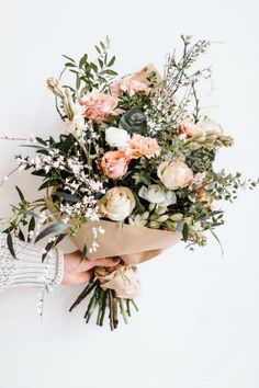 a person holding a bouquet of flowers in their hand