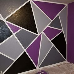 a room with purple, black and grey walls