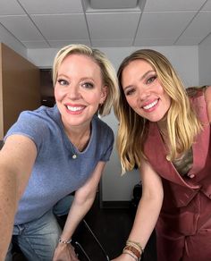 two women are smiling and posing for the camera