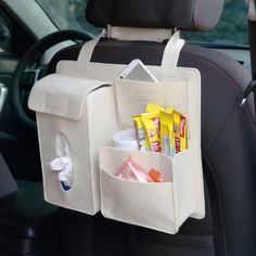 the back seat pocket is holding two bags with food in it and drinks in them