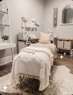 a white bed sitting in a bedroom on top of a wooden floor next to a desk