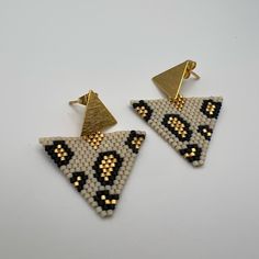 Description: Dainty Triangle Leopard Print Miyuki Earrings These Items Are Individually Made With Love By Me Details: Handmade Item Materials: Miyuki Seeds & 18k Gold Hypo-Allergenic Stainless Steel Posts Includes Rubber Backs Color: Gold, White, & Black Shape: Triangle Dimension: 2” Style: Boho Chic / Animal Print / Stylish Care Instructions: Store Out Of Direct Sunlight And Keep Away From Water. Trendy White Dangling Bead Earrings, White Triangle Earrings For Gift, Trendy White Dangling Beads Earrings, Trendy White Earrings With Dangling Beads, Handmade White Beaded Earrings Trendy Style, Handmade Trendy White Beaded Earrings, Handmade White Trendy Beaded Earrings, White Handmade Trendy Beaded Earrings, Handmade White Triangle Beaded Earrings