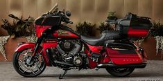 a red and black motorcycle parked in front of a building