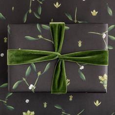 a present wrapped in green velvet and tied with a bow