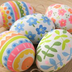 painted easter eggs in a basket on a table