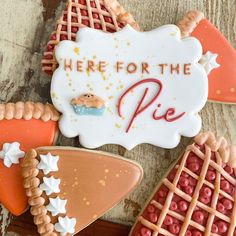 there is a sign that says here for the pie on it and some cookies in different shapes