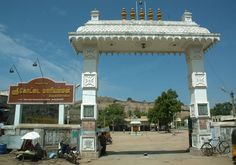 an entrance to a small town with people walking around